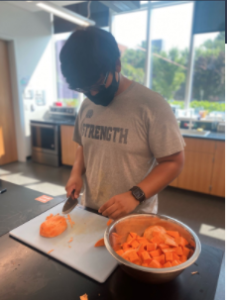 Tenzin Rabga chopping sweet potatoes during an R&D session in the Food Lab